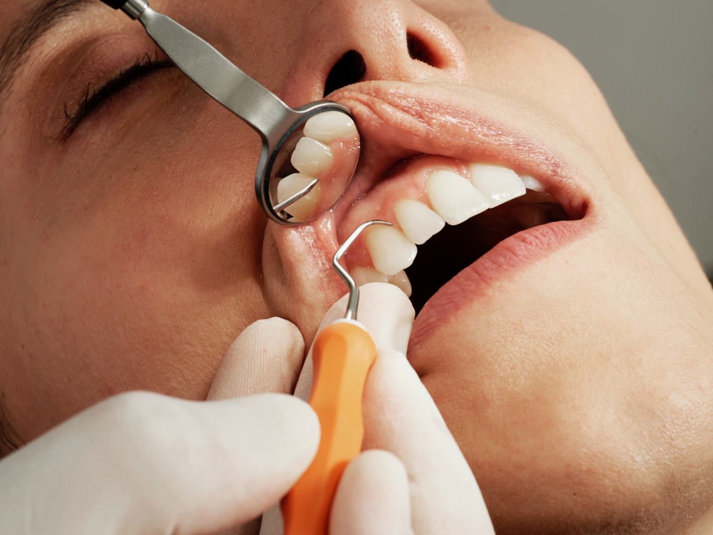 A dentist checking a patient's teeth