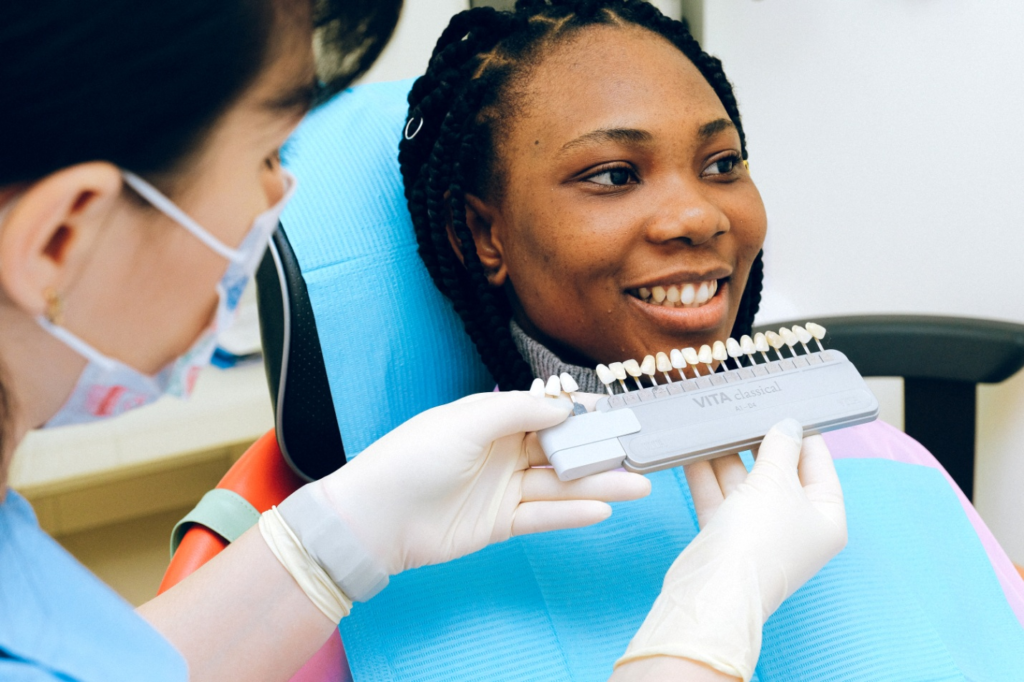 A dentist showing newly installed dental restoration to her patient