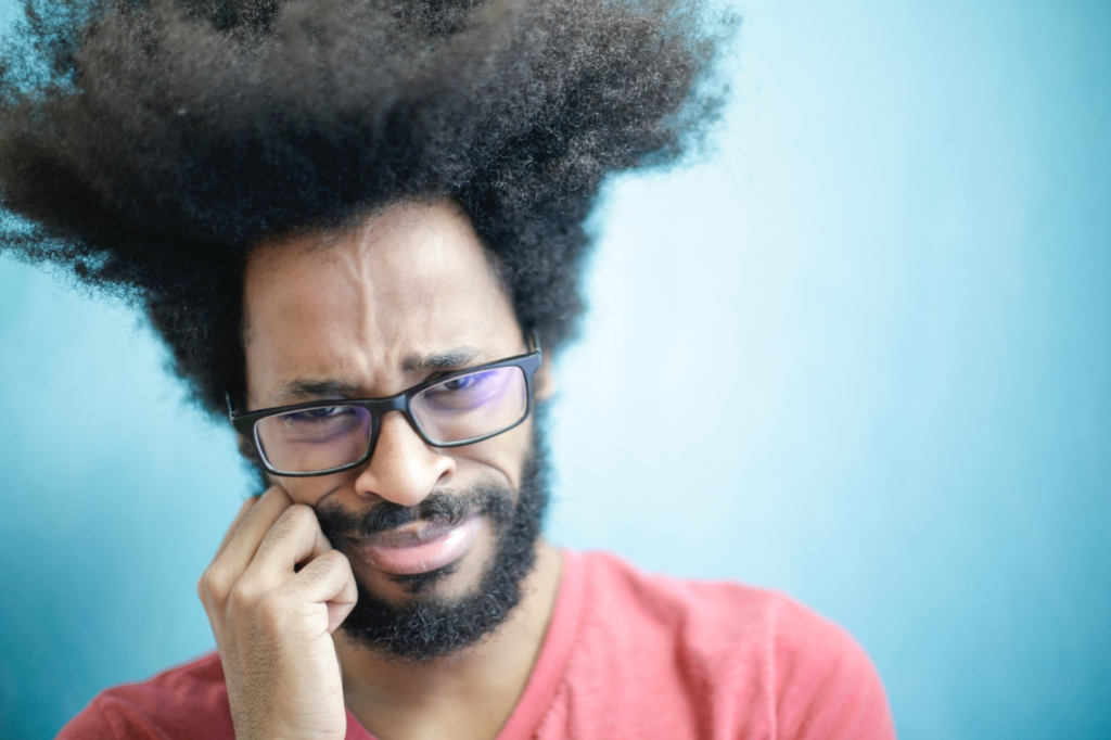 A man pressing his hand on his cheek because of toothache