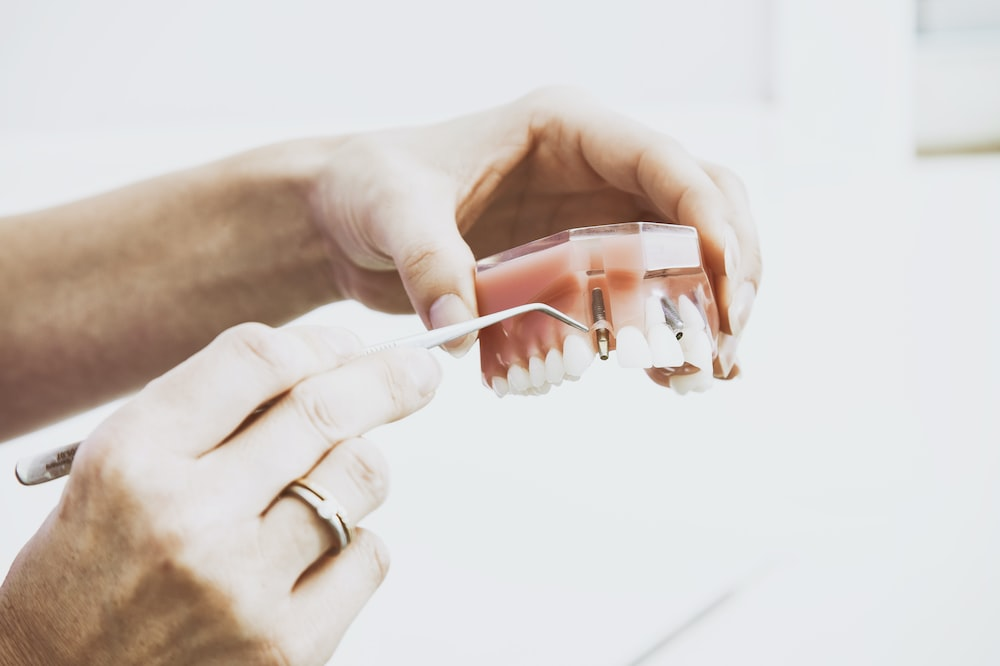 An image of a person holding dental equipment