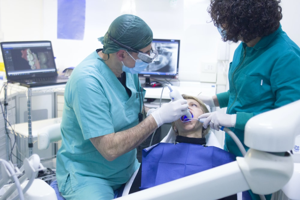 An image of dentists treating a young patient