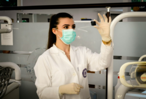 An image of a woman wearing a mask inside a lab
