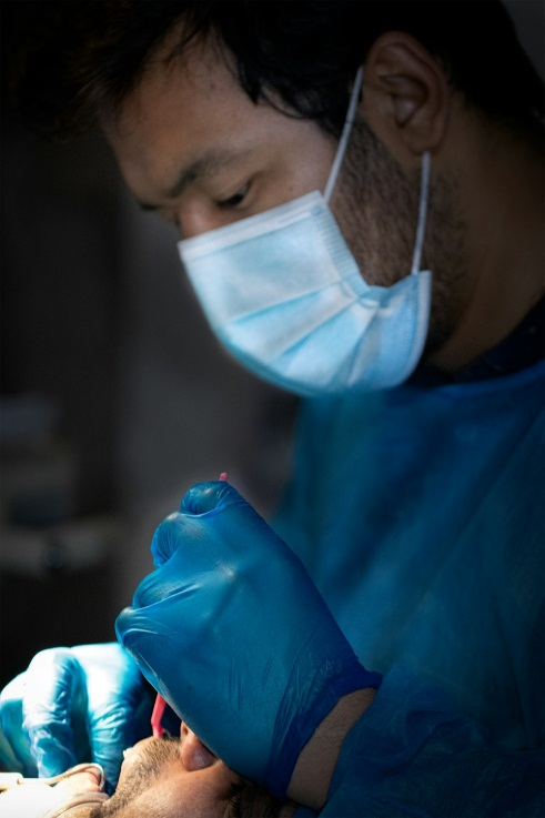 A person getting a dental treatment from a dentist