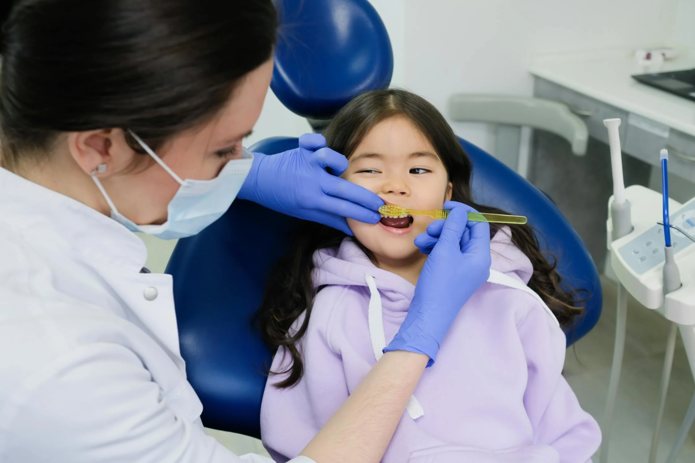 a young kid sitting in a dental chair