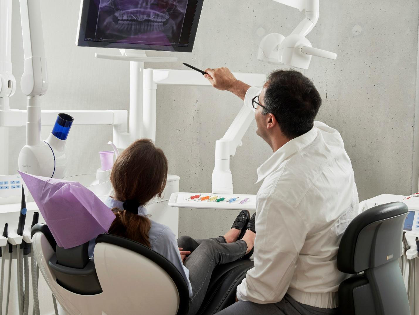 A dentist explaining an x-ray to a patient
