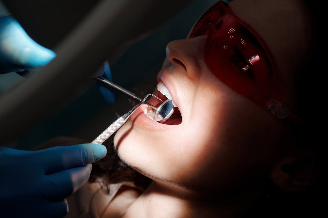 A patient getting their teeth examined