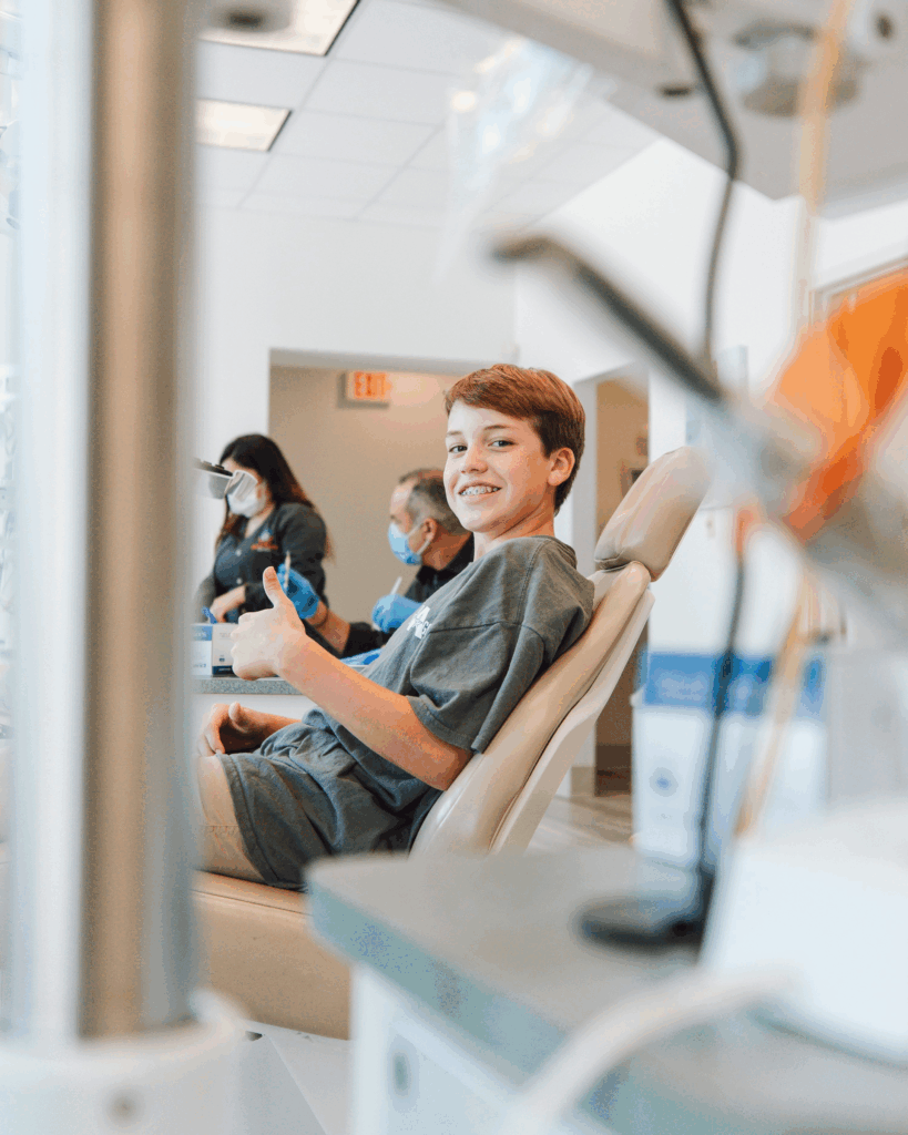 Boy smiling in a dental chair