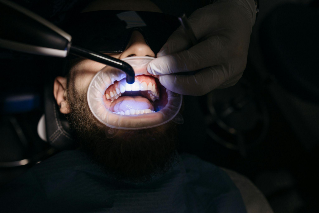 This photo shows a patient getting ultraviolent treatment for his teeth