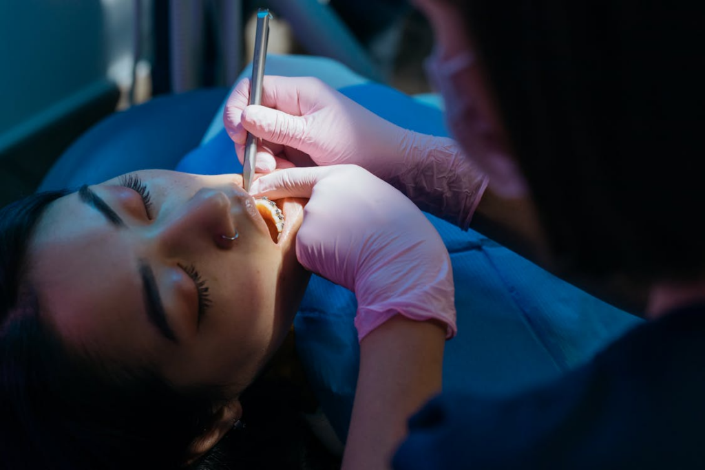 Dentist performing a root canal procedure on a patient using dental tools