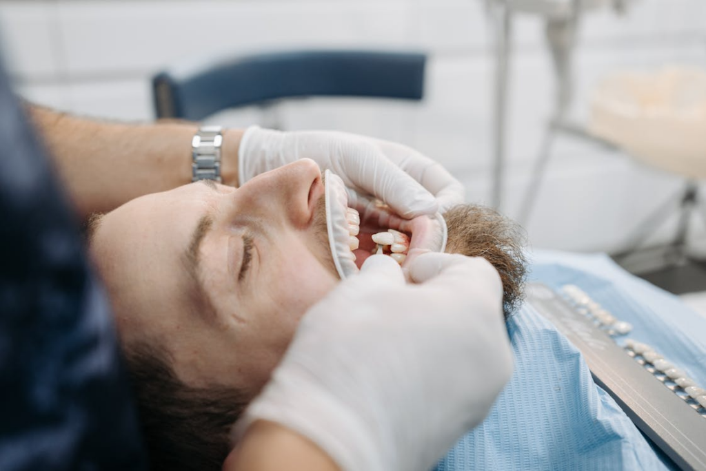 Dentist placing a dental crown on a patient’s tooth during treatment