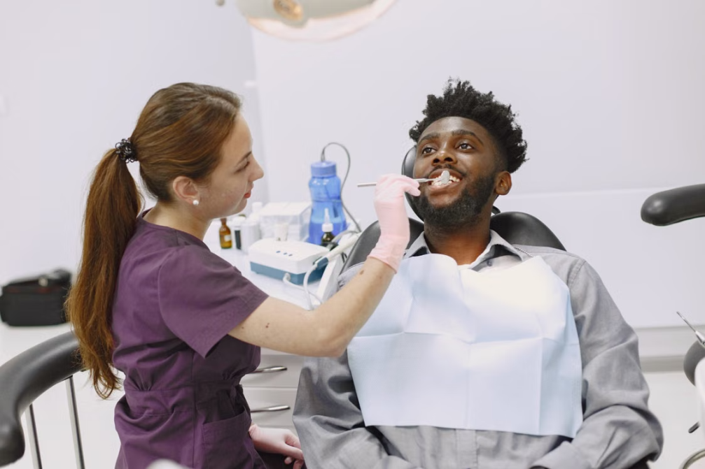 Dental practitioner examining a seated patient